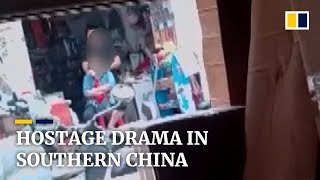 Hostage drama in China Woman taken captive by man with knife [upl. by Lerrehs]